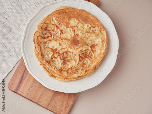 Thin pancakes crepes in a plate. Tradicional asturian desert.Top view. photo