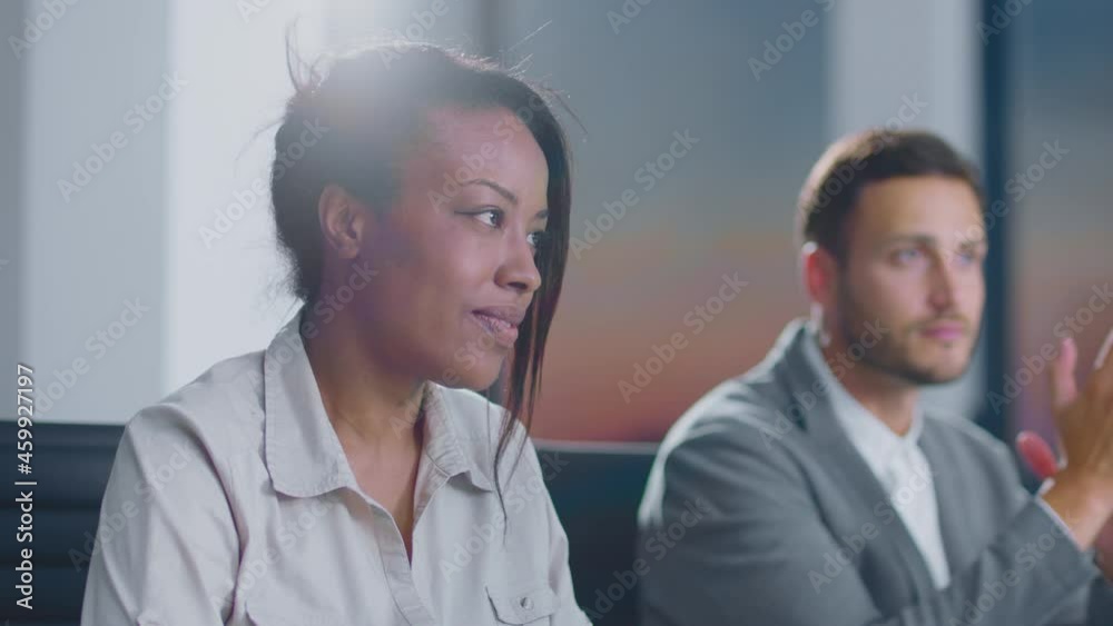 Business meeting in company. Colleagues sitting in row at table and speaking. Modern open space office interior. Business meeting in company. Colleagues sitting in row at table and speaking. Modern open space office interior.