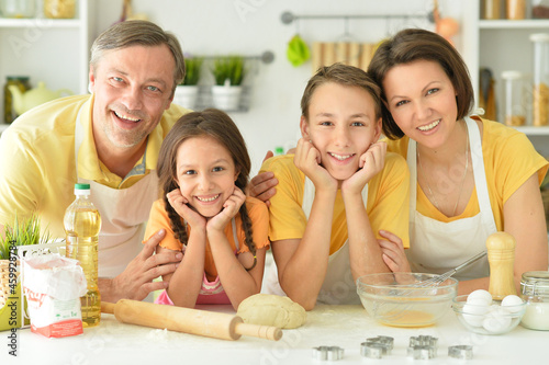 Portrait of happy family baking together in the kitchen