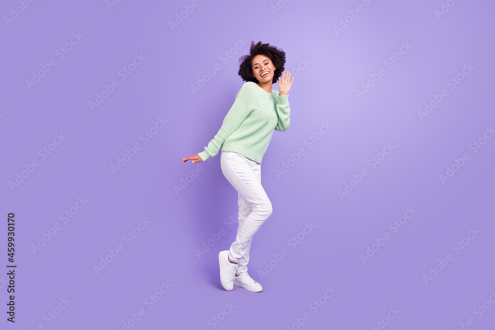 Full body photo of young dark skin woman dance good mood casual outfit isolated on purple color background