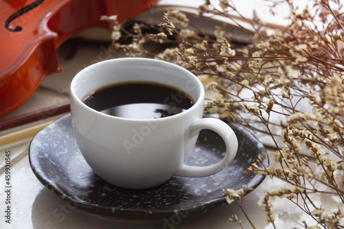 White ceramic cup with black coffee put on background