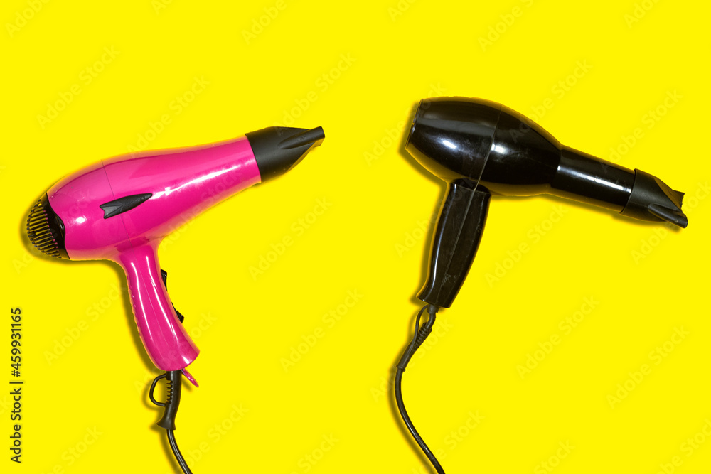 different colors of hair dryer isolated on yellow background. Domestic Small Appliances. Household Equipment. Electric Home Appliance. Professional Hair Style Tool different colors of hair dryer isolated on yellow background. Domestic Small Appliances. Household Equipment. Electric Home Appliance. Professional Hair Style Tool