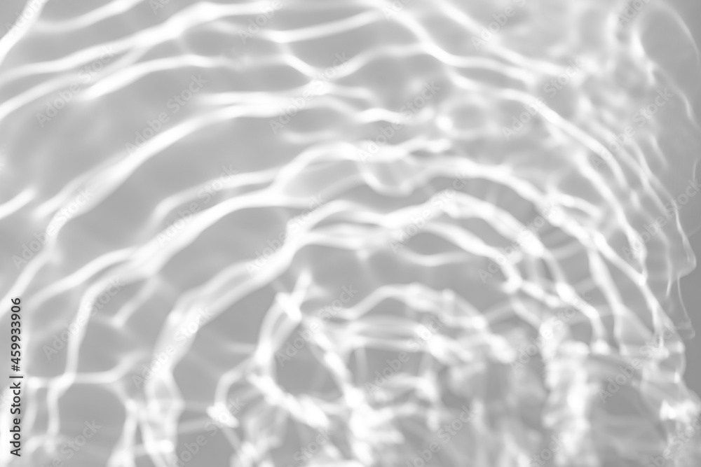 Blurred defocused water texture overlay effect for photo and mockups. Organic drop diagonal shadow and light caustic effect on a white wall. Shadows for natural light effects Blurred defocused water texture overlay effect for photo and mockups. Organic drop diagonal shadow and light caustic effect on a white wall. Shadows for natural light effects