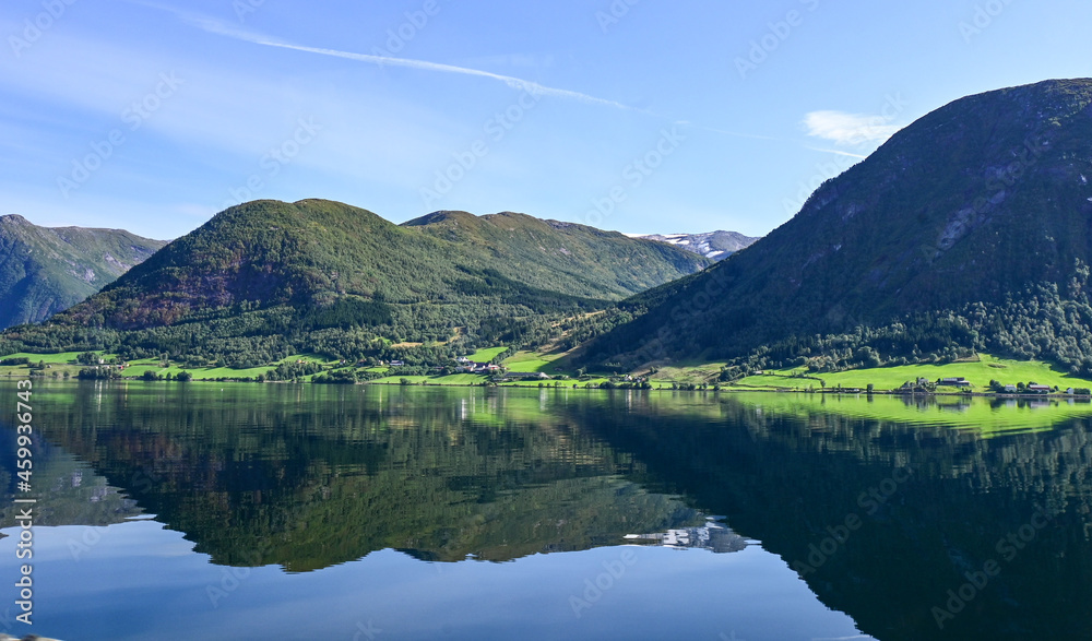 Reflection of mountains in a beautiful Norwegian fjord in summer