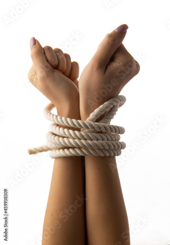 Tied female hands on white background.