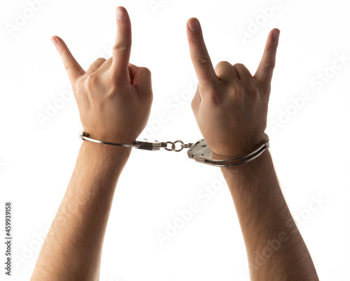 Handcuffed hands isolated on white background.