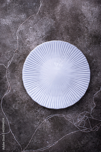 Plate on grey concrete background