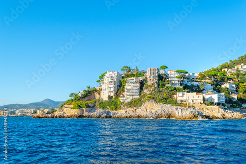 View from the Mediterranean Sea of the Saint Jean Cap Ferrat lighthouse, in Saint-Jean-Cap-Ferrat, France along the French Riviera. photo