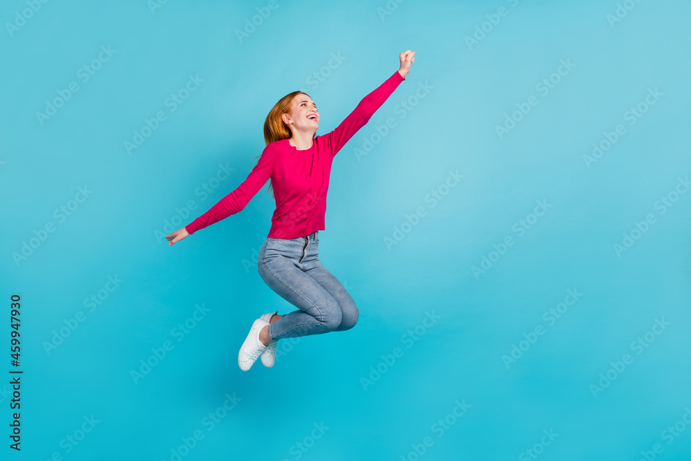 Full length body size view of attractive cheerful girl jumping striving success goal isolated over vivid blue color background