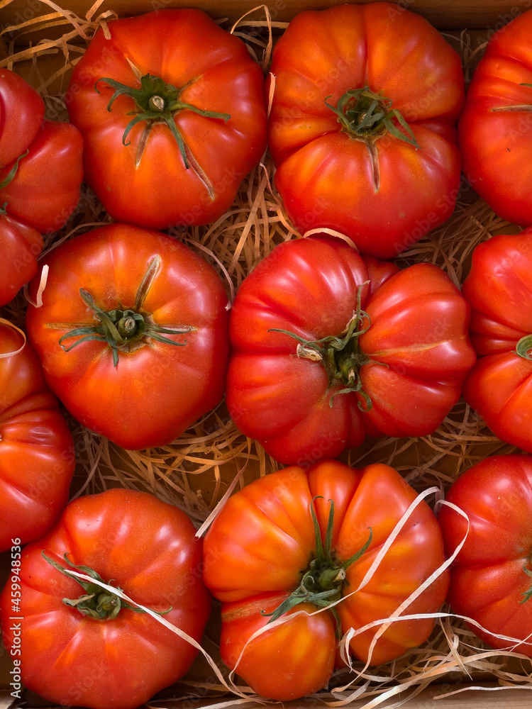 Beef heart tomato in its basket in a rural farm shop in the south of france Beef heart tomato in its basket in a rural farm shop in the south of france