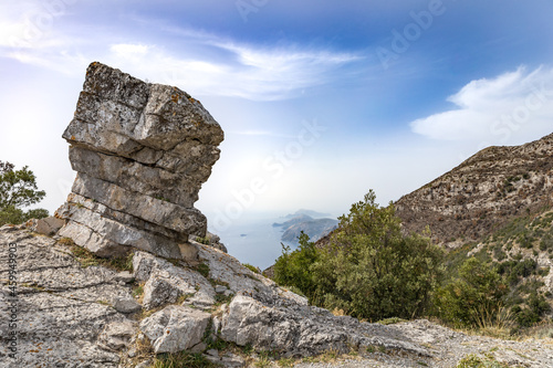 Capo Muro peack a rock to shape of mushroom on a path of the Amalfi coast with Capri  in background.  Agerola, Positano, Campania, Italy photo