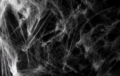 Spider web on black background. Halloween banner. Copy space. Selective focus.