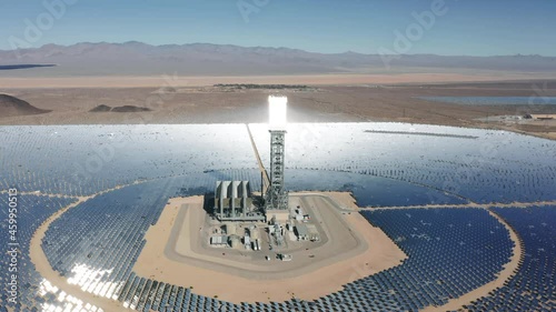 Breathtaking aerial panorama view around solar towers reflecting sun rays on solar panels. Desert heliostat on sunny day. Aerial 4K Ivanpah Solar Electric Generating System in Nipton California Nevada