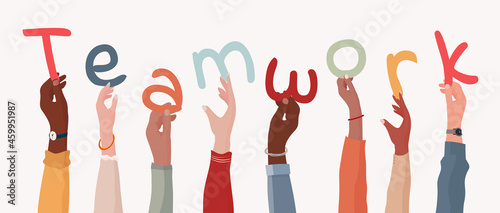 Group of arms and raised hands of diverse multicultural business people holding a letters forming the text -Teamwork- Collaboration between colleagues or co-workers. Community. Banner