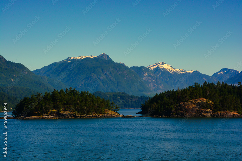 Small islands in front of mountains on the coast