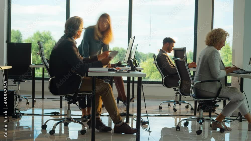 Timelapse footage of people working on computer and speaking together. Modern open space office interior.
