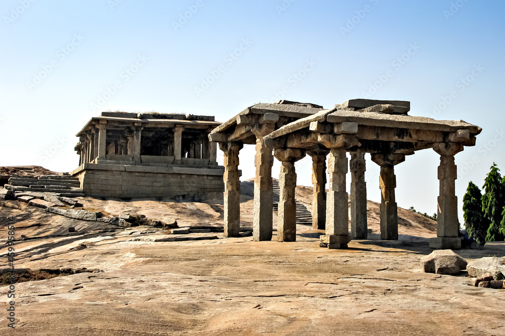 Ancient stone temple in solid rocks on hill in Hampi, Karnataka, India.