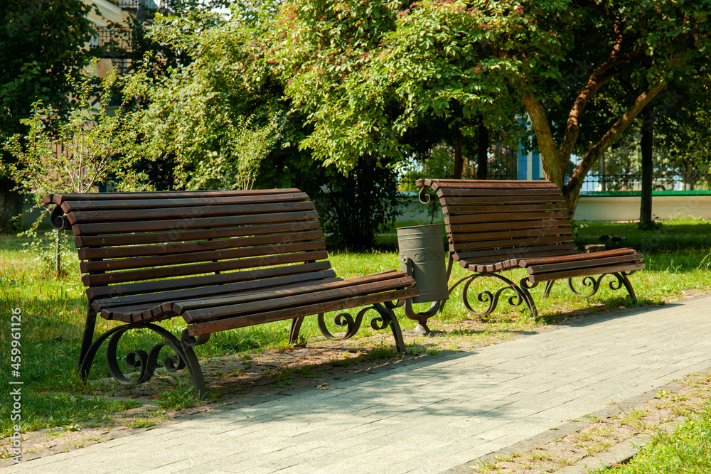 Empty wooden benches in city park
