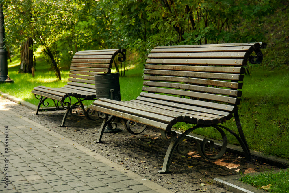 Empty wooden benches in city park Empty wooden benches in city park