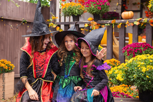 Happy Halloween! funny kids girls laughing in fancy dress in the open