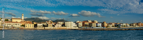 Panorama of the city of San Vincenzo, seen from the sea. Blue sky and clouds. Livorno, Tuscany, Italy