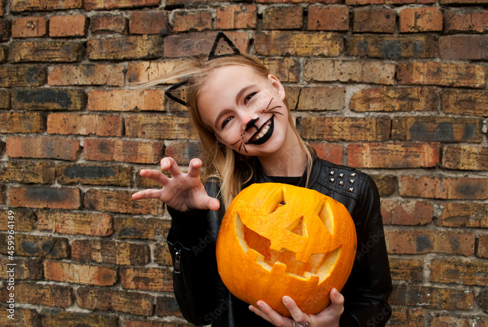 Beautiful teenager girl dressed as a black cat for Halloween. Child ...