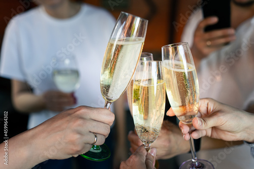 Friends raise glasses of champagne at a party