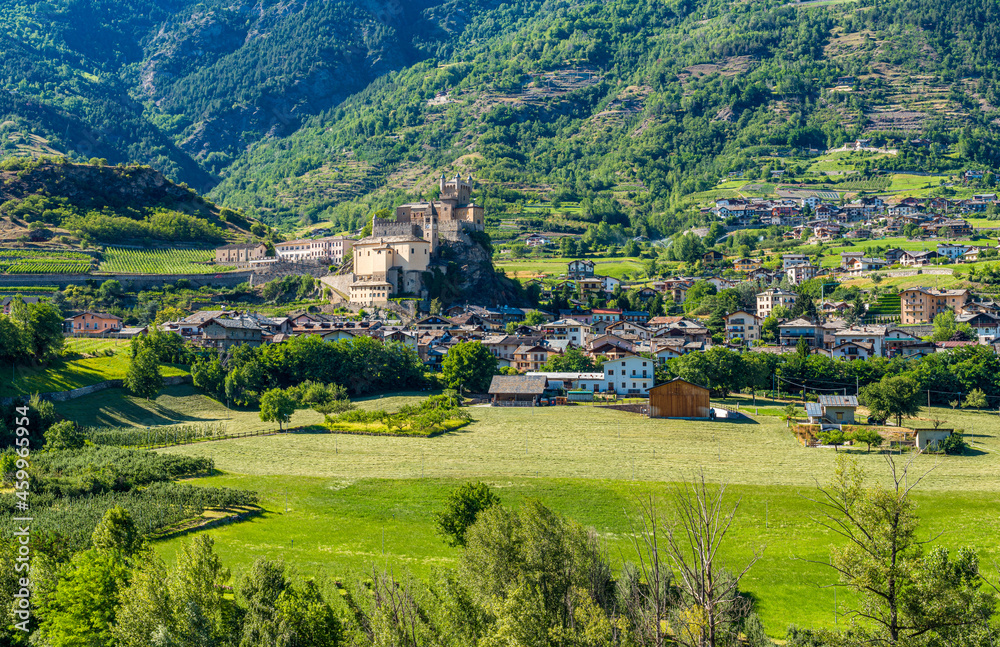 The village of Saint Pierre with its beautiful castle on a summer afternoon. Aosta Valley, northern Italy.