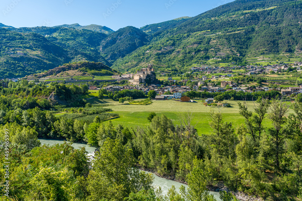 The village of Saint Pierre with its beautiful castle on a summer afternoon. Aosta Valley, northern Italy.