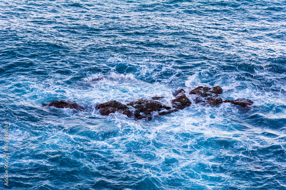 Fototapeta premium High angle view of waves crashing on rocks.