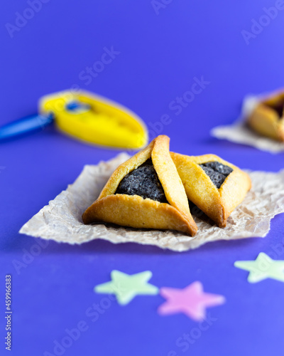 Traditional Jewish triangular hamantaschen cookies with poppy filling. Purim celebration concept. . photo