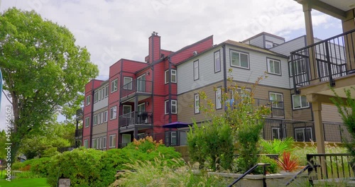 Wallpaper Mural Establishing shot of modern apartment building with balcony, trees and beautiful landscape in Vancouver, Canada, North America. Day time on July 2021. ProRes 422 HQ. Torontodigital.ca