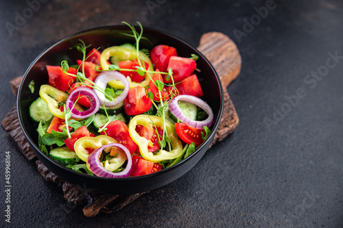 vegetable salad fresh tomato, cucumber, pepper, onion, olive oil healthy veggie meal snack on the table copy space food background rustic keto or paleo diet vegan