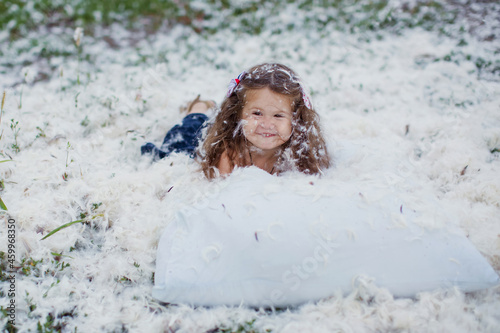 Feathers pillow mess and happy child