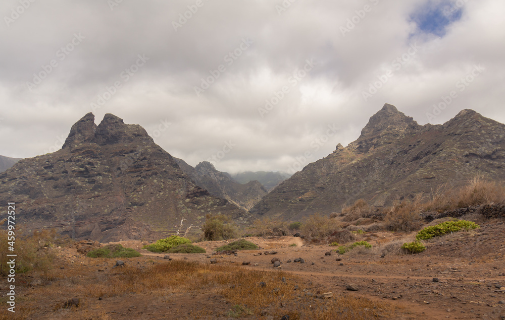 large brown and stony mountains in an arid locality of the canary islands under cloudy sky