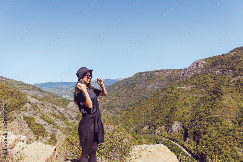 Young woman with hat enjoying the beautiful high mountain view .Bov Village, Balkan Mountain, Iskar Gorge