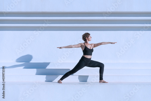 Woman in yoga warrior outdoors