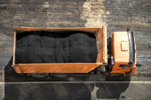 A dump truck full of asphalt mix. Road repair concept. Top view.