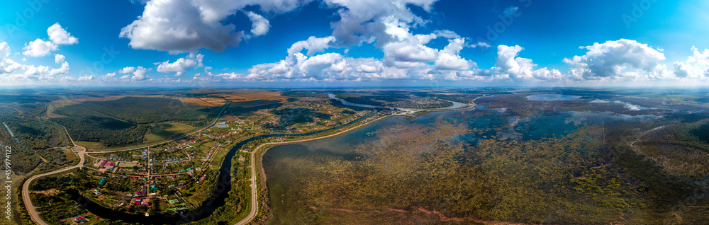 a large aerial panorama of the Afipsip village near the Kuban River and the drying up Shapshug reservoir (Adygea, South of Russia) on a sunny day in early autumn