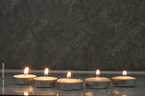 five small candles burn and stand in a triangle. side view. Divination Halloween Mystic