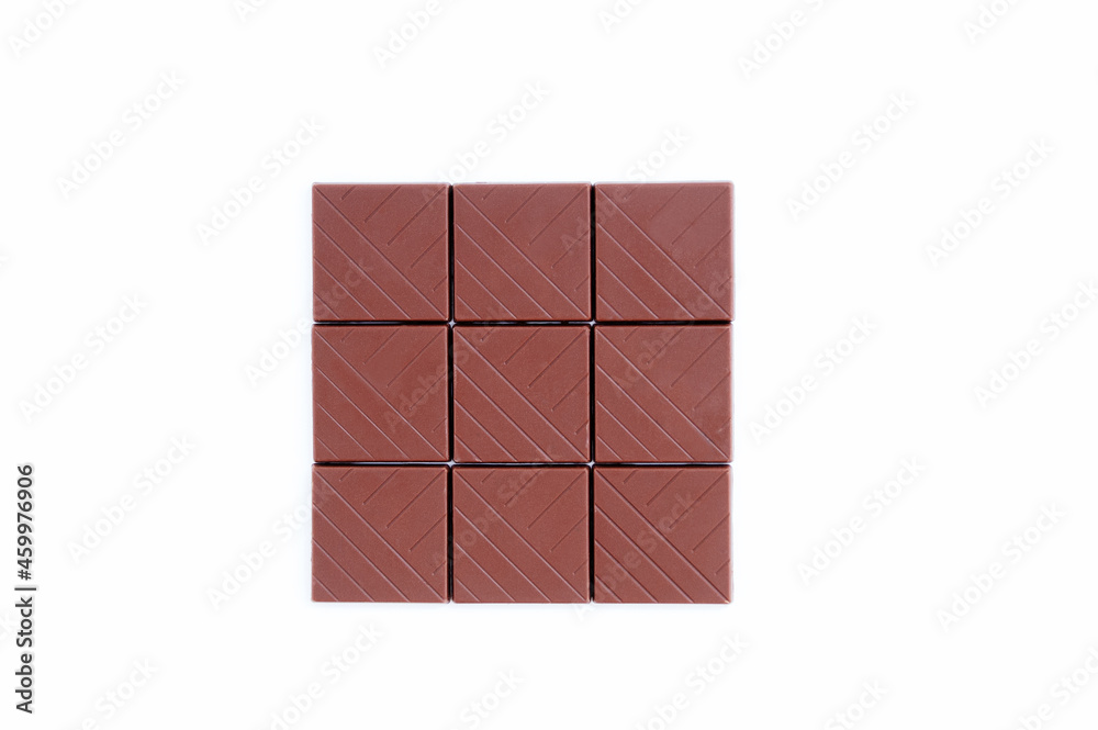 Bars of slices of milk chocolate on white background. Bars of slices of milk chocolate on white background.