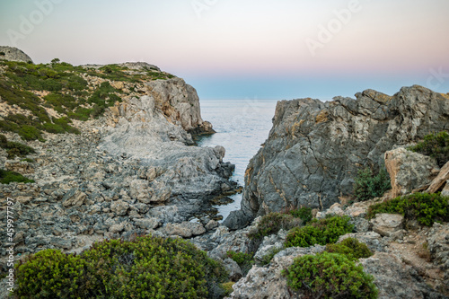 Rocky shore at sunset near Anthony Quinn Bay in Rhodes, Greece