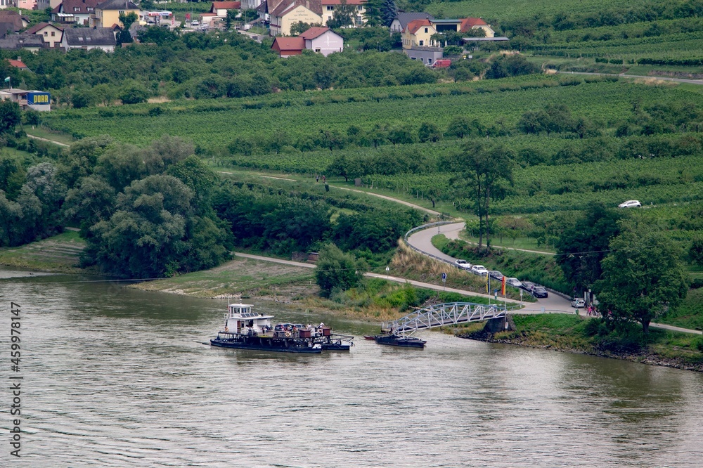 Ferry ship on a Danube river in Austria near Spitz town with cars waiting to be transported Ferry ship on a Danube river in Austria near Spitz town with cars waiting to be transported