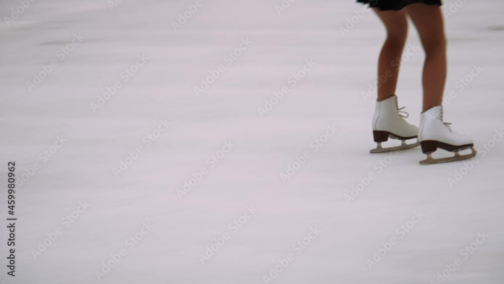 Teenage Ice Skater Skating Backwards And Spinning Teenage Ice Skater Skating Backwards And Spinning