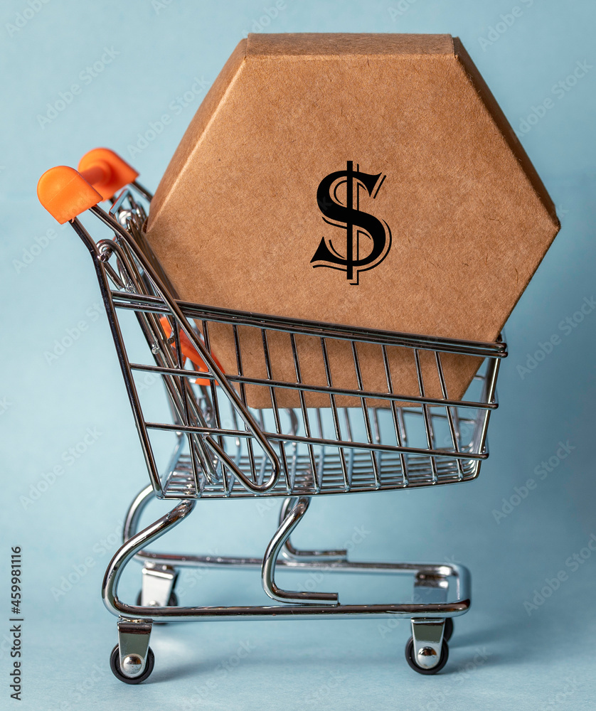 A hexagonal cardboard box inside a shopping trolley. A USD symbol is  printed on the box. Stock Photo | Adobe Stock
