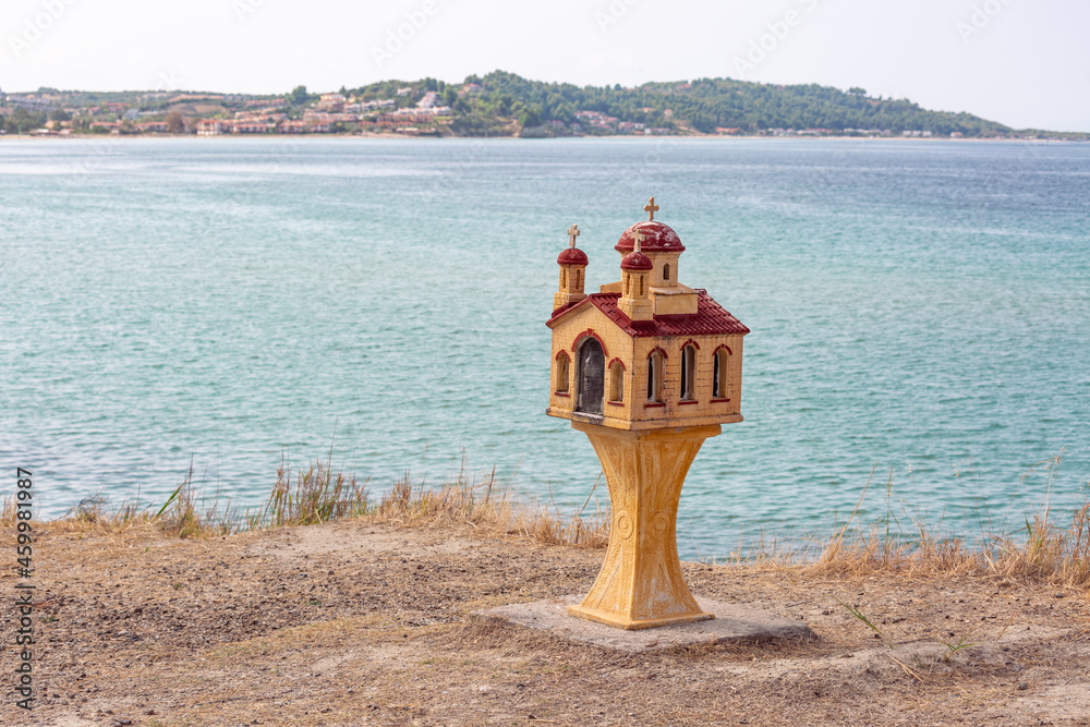 Traditional and memorial small chapel or church in Greece with sea in background Traditional and memorial small chapel or church in Greece with sea in background