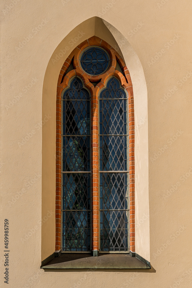 Old vaulted window from an apricot colored church in Sweden
