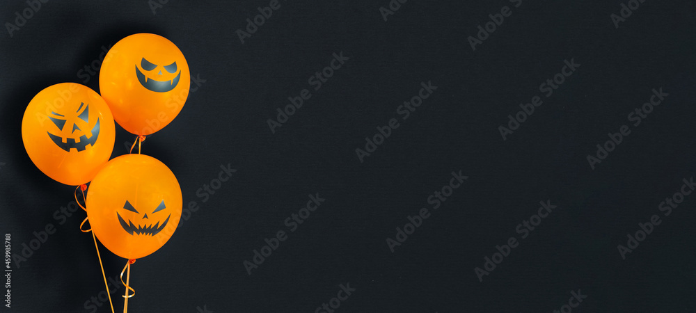 Orange balloons with no glare isolated on textured black background for  Happy Halloween celebration. Halloween banner with helium balloons with  scary pumpkin faces with copy space. Stock Photo | Adobe Stock