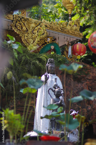 Chinese Bodhisattva or Goddess of Compassion, Mercy and Kindness statue, also known as, Guan Yim or Dewi Kwan Im at Thailand Buddhism Shrine Nam Hai Kwan Se Im Pu Sa Vihara Sukabumi, Indonesia. photo