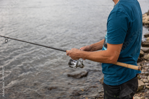 Close-up of a male fisherman holding his hinge